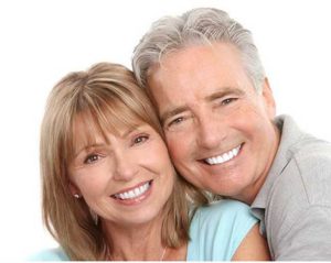 couple smiling happily together - inlays and onlays